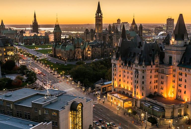 Ottawa from the air, looking north west along Wellington from Laurier bridge. Overlooking Parliament at sunset. Image courtesy of Ottawa Tourism.